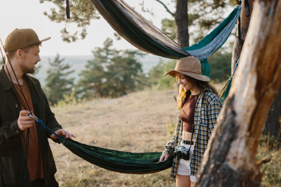 Young couple hanging hammocks in forest with scenic view – Good Friday Wellness magic mushrooms
