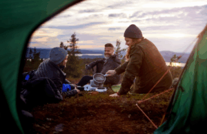 Friends camping and laughing at sunset with Good Friday Wellness Psilocybin Magic Mushrooms.