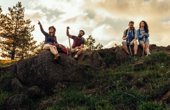 Group of friends enjoying nature on a rocky hillside during a wellness hike with Good Friday Wellness Psilocybin Magic Mushrooms.