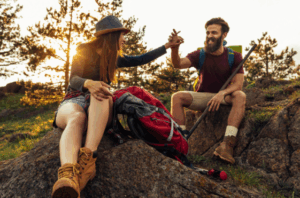 Couple hiking in nature enjoying sunset after a Good Friday Wellness magic mushroom delivery.