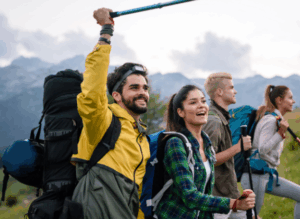 Group of hikers celebrating on a mountain trail while enjoying the benefits of Good Friday Wellness magic mushrooms