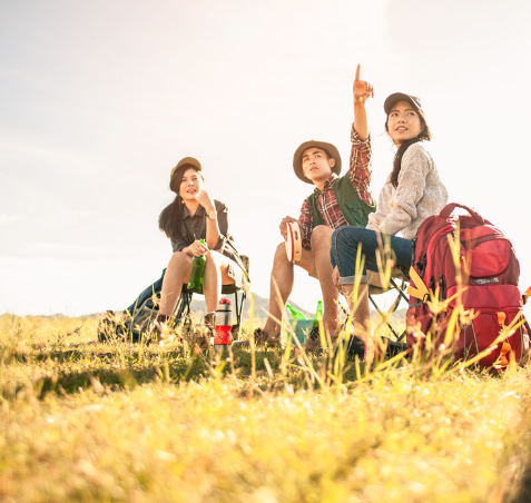 Young adults camping outdoors enjoying nature and connecting under the influence of Good Friday Wellness Psilocybin Magic Mushrooms