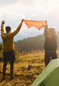 Campers embracing nature’s glow while feeling elevated by Good Friday Wellness magic mushroom capsules.