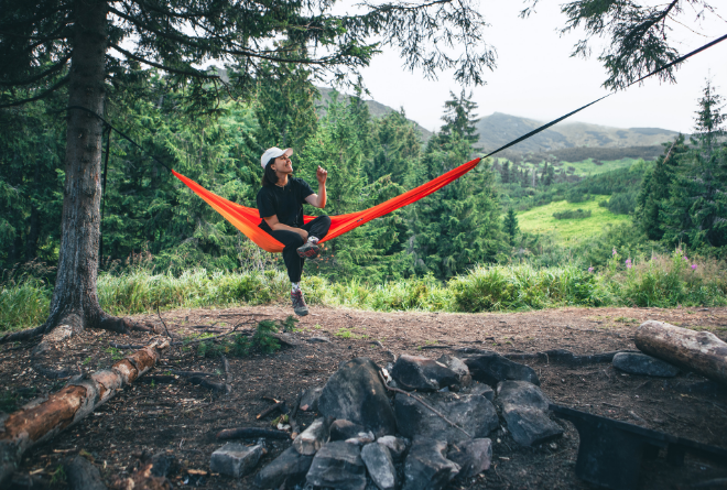 Camper relaxes in hammock after receiving Good Friday Wellness magic mushroom delivery.