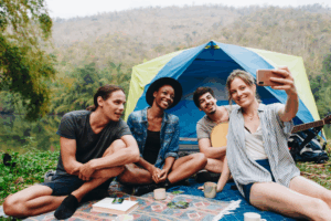Friends bonding at a forest campsite with Good Friday Wellness magic mushrooms