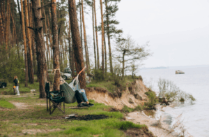 Camper in hammock by lakeside forest cliff – Good Friday Wellness magic mushroom delivery