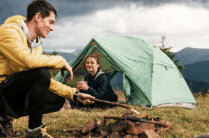 Couple enjoying campfire and tent in the mountains – Good Friday Wellness magic mushrooms