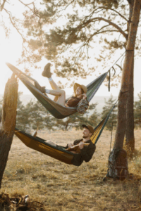 Couple relaxing in double hammock among pine trees – Good Friday Wellness Psilocybin Magic Mushrooms