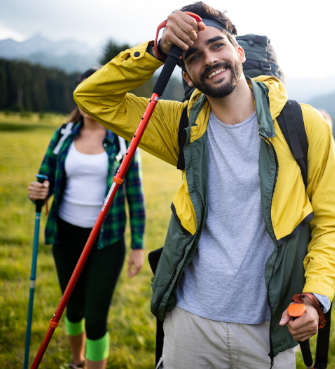 Smiling hiker resting with backpack and poles – Good Friday Wellness magic mushrooms