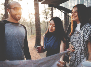 Friends planning their forest camping trip with Good Friday Wellness magic mushrooms