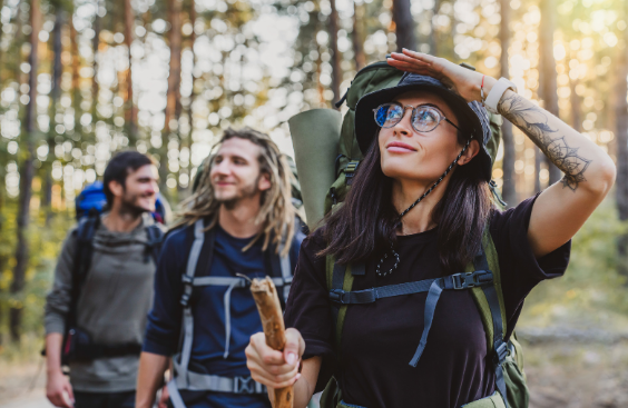 Woman leading hike through forest while exploring with Good Friday Wellness magic mushrooms