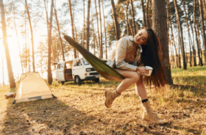 Woman relaxing in hammock with coffee during a peaceful sunrise, enhanced by Good Friday Wellness Psilocybin Magic Mushrooms.